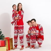 Božićna porodica koja odgovara pidžami postavlja božićnu kuću za božićnu kuću